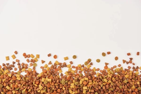 View from above of pile of dog food on white surface — Stock Photo