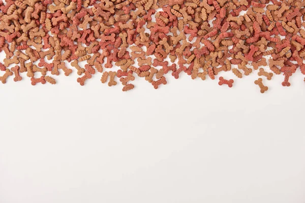 Elevated view of pile of pet food on white surface — Stock Photo