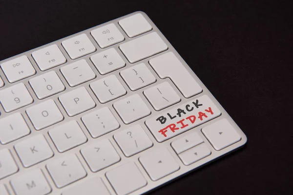 Close-up shot of computer keyboard with black friday button isolated on black — Stock Photo