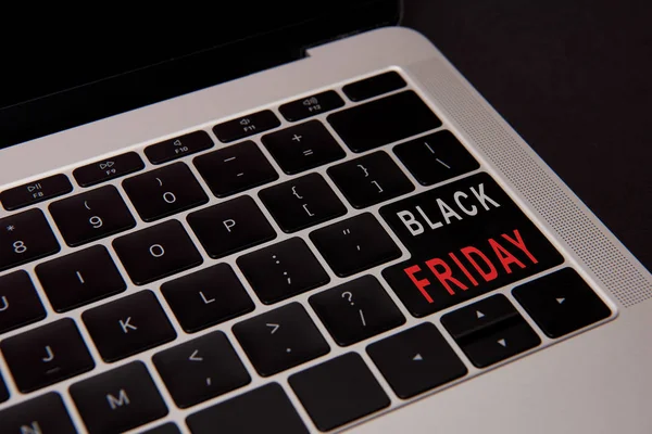 Close-up shot of laptop keyboard with black friday button isolated on black — Stock Photo