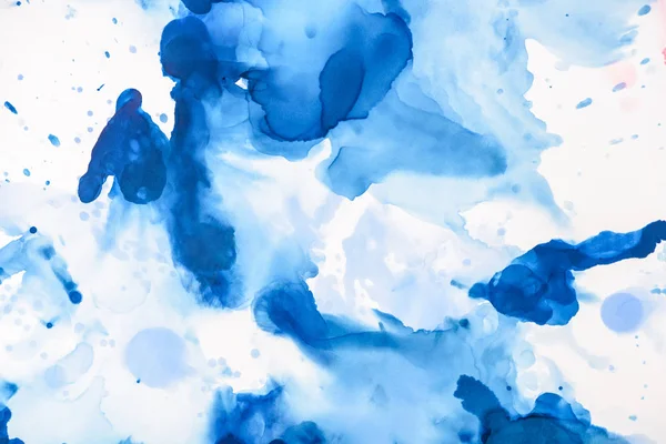 Blue splashes of alcohol ink on white as abstract backdrop — Stock Photo