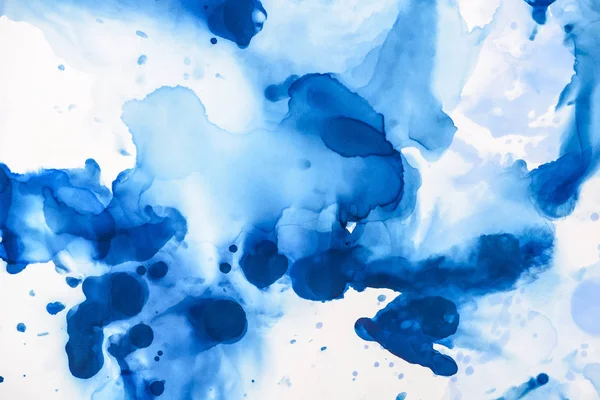 Beautiful blue splashes of alcohol ink on white as abstract background — Stock Photo