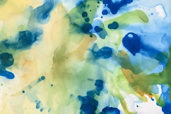 Yellow, green and blue splashes of alcohol inks as abstract background — Stock Photo