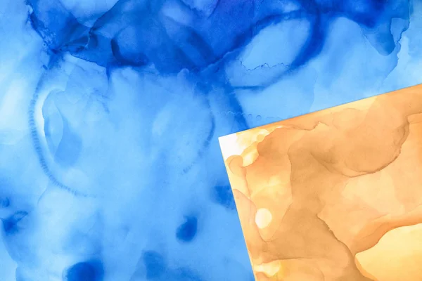 Beautiful blue and yellow splashes of alcohol inks as abstract background — Stock Photo