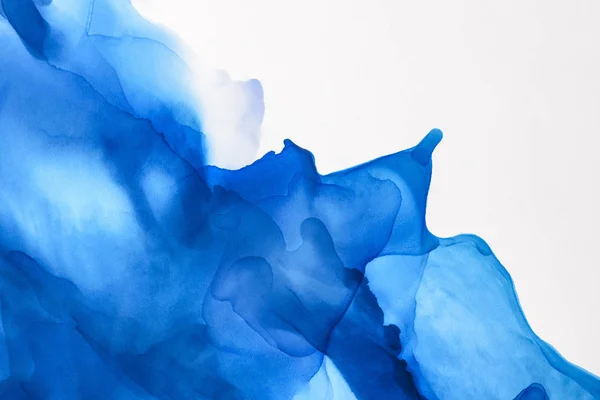 Blue splashes of alcohol ink on white as abstract background — Stock Photo