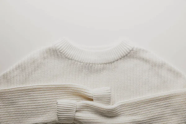 Top view of white woolen sweater on white surface — Stock Photo