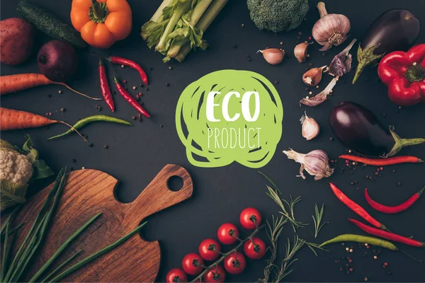 Vista dall'alto di diverse verdure e tagliere in tavola con scritte eco product — Foto stock