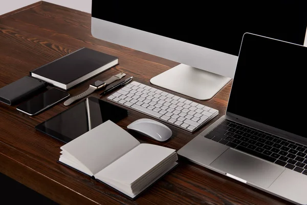 Modern workplace with various devices on wooden table — Stock Photo