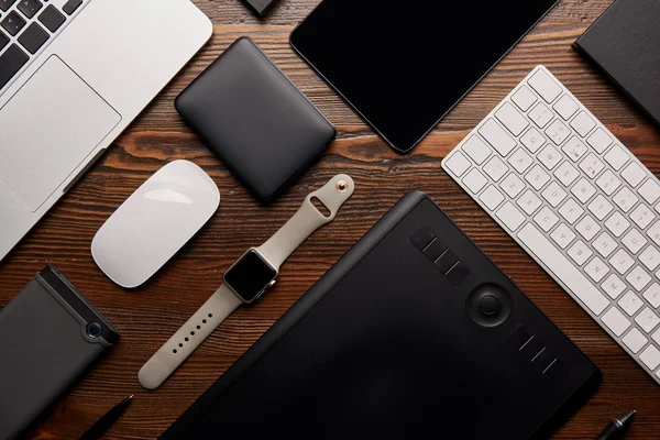 Flat lay with different devices on wooden workplace — Stock Photo