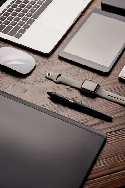 Close-up shot of different modern gadgets on retoucher workplace — Stock Photo