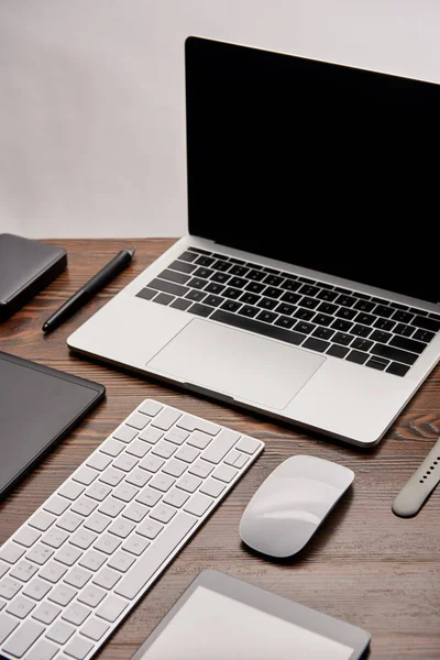 Close-up shot of laptop with other various gadgets on graphics designer workplace — Stock Photo