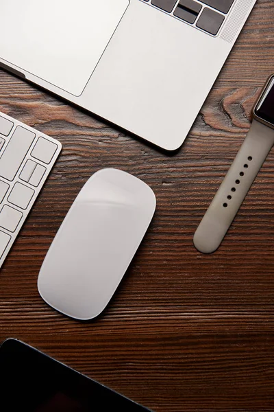 Top view of various wireless devices on wooden table — Stock Photo