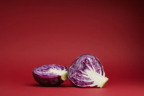 Fresh ripe organic sliced purple cabbage on red background — Stock Photo