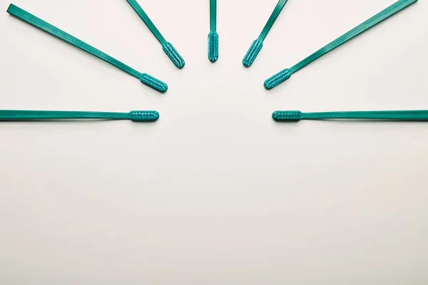 Flat lay with arrangement of toothbrushes on white background — Stock Photo