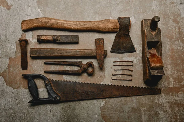 Top view of various rusty carpentry tools on old background — Stock Photo