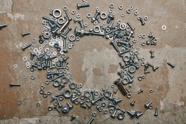 Top view of screws and bolts on the background of old  surface — Stock Photo