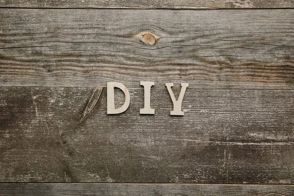 Top view of wooden diy sign on wooden background — Stock Photo