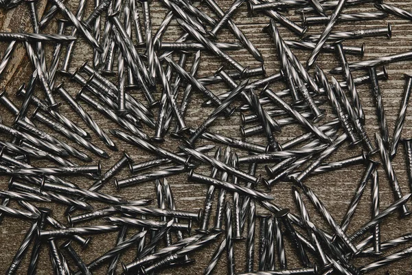 Top view of nails arranged on wooden table — Stock Photo