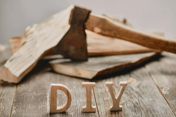 Close up of diy sign on wooden table on the background of logs and axe — Stock Photo