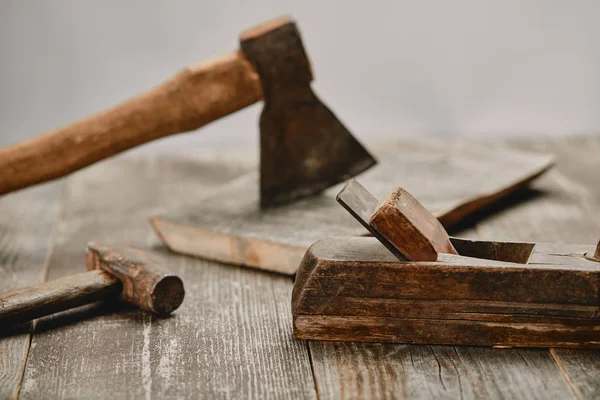 Close up view little wood construction, hammer and axe on wooden table on grey background — Stock Photo