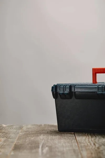 Close up of tools box on wooden table on grey background — Stock Photo