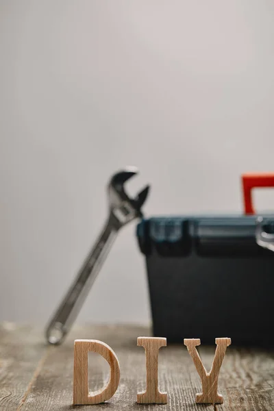 Do it yourself sign on wooden table on the background of tool and tools box — Stock Photo