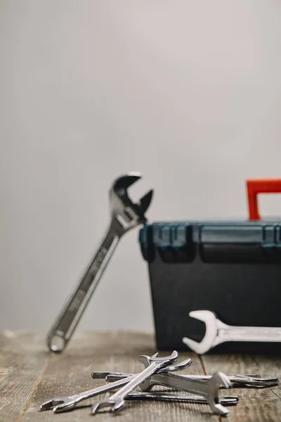 Close up of various tools on wooden table on grey background — Stock Photo