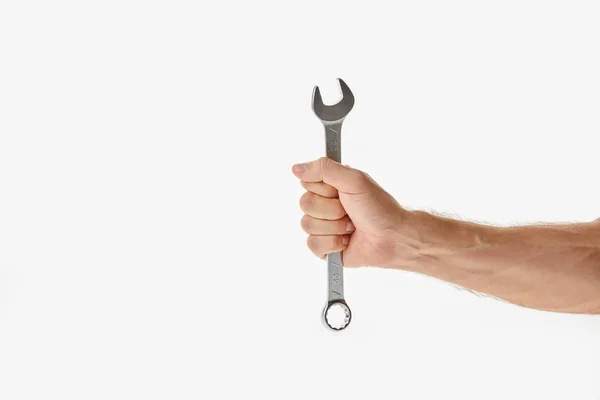 Partial view of man holding wrench isolated on white — Stock Photo