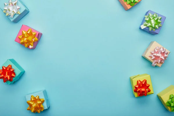 Vista superior de los regalos de colores sobre fondo azul - foto de stock