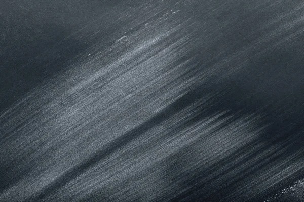 Full frame image of black table with flour strokes — Stock Photo