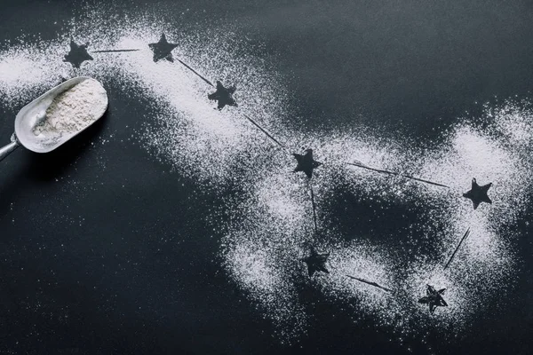 Elevated view of scoop on table covered by flour with stars as big dipper constellation — Stock Photo