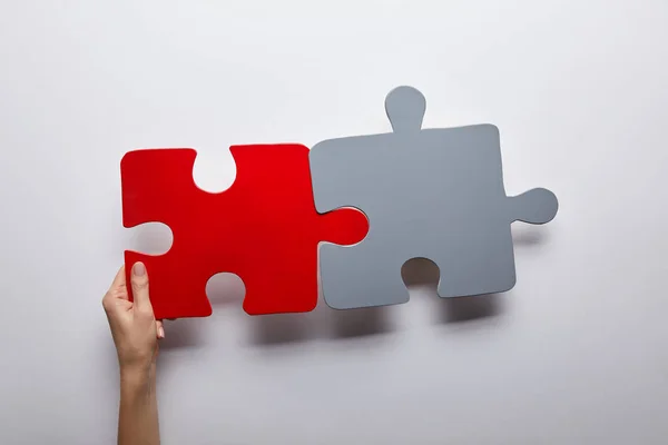 Vue du haut des puzzles rouges et gris problème solution symbole sur fond gris — Photo de stock