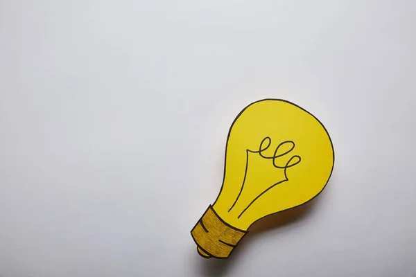 Draufsicht auf das Glühbirnen-Ideensymbol auf grauem Hintergrund — Stockfoto