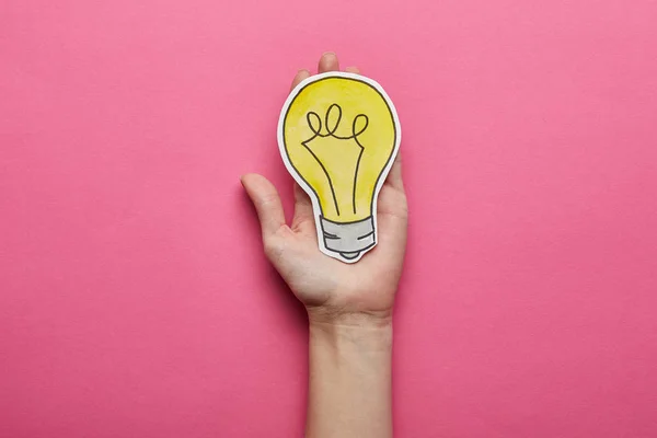 Top view of yellow light bulb idea symbol on pink background — Stock Photo