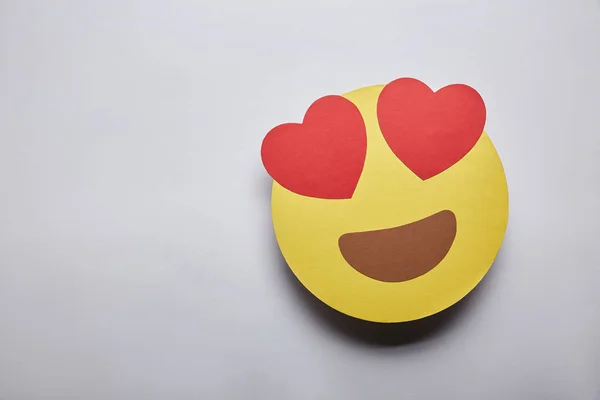 Elevated view of in love emoticon on grey background — Stock Photo