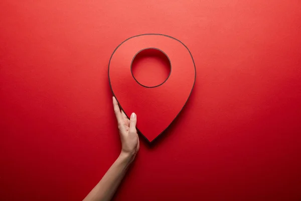 Top view of red handmade geolocation symbol on red background — Stock Photo