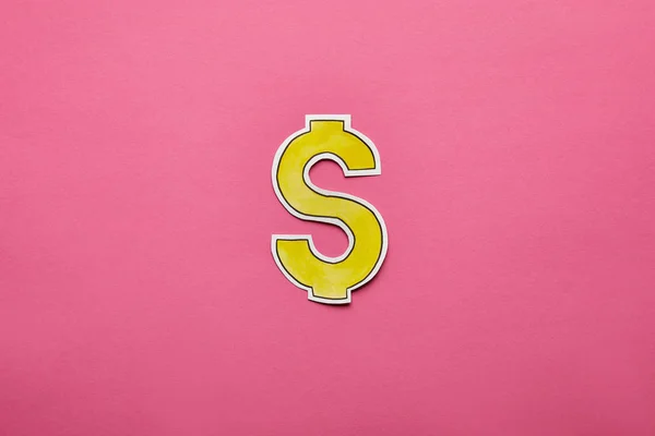 Top view of dollar sign on pink background — Stock Photo