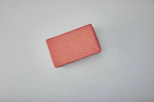 Top view of wrapped present on grey background — Stock Photo