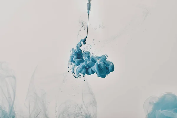 Blue watercolor paint splash from syringe — Stock Photo