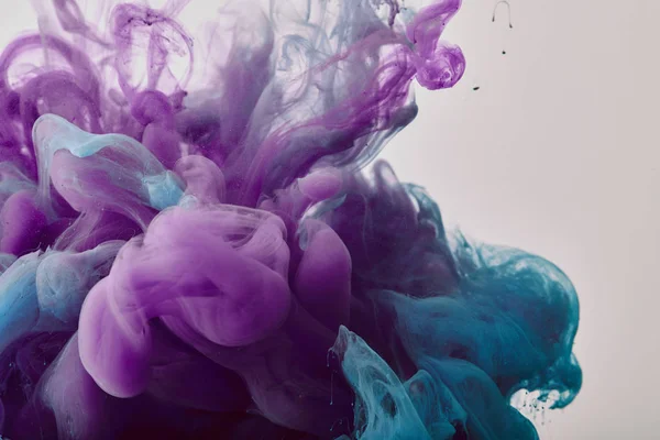 Abstract background with purple and blue swirls of gouache paint — Stock Photo