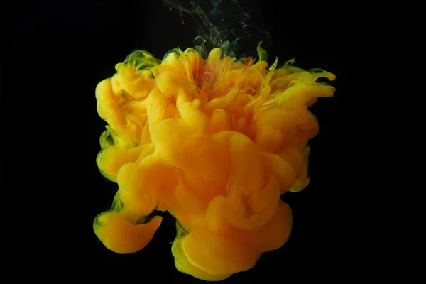 Close up view of orange splash of paint isolated on black — Stock Photo