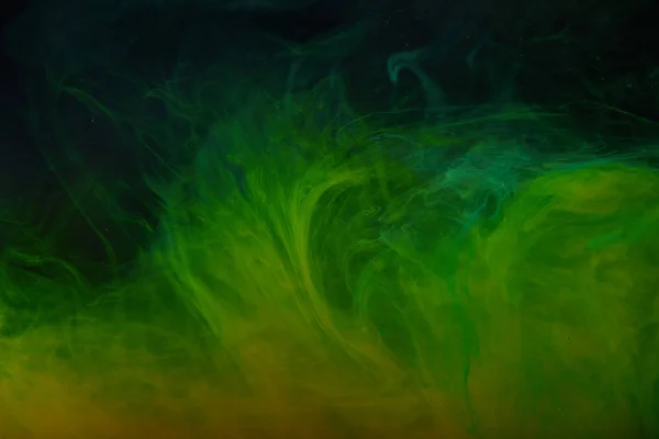 Abstract background with green swirls of acrylic paint in water — Stock Photo