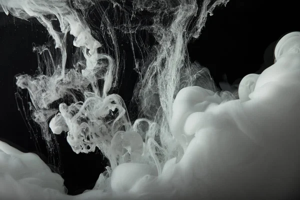 Abstract monochrome flowing swirls of paint in water — Stock Photo