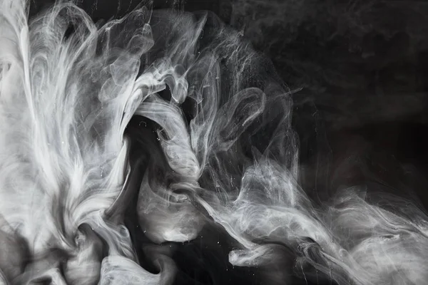 Close up view of abstract flowing swirls of grey paint — Stock Photo