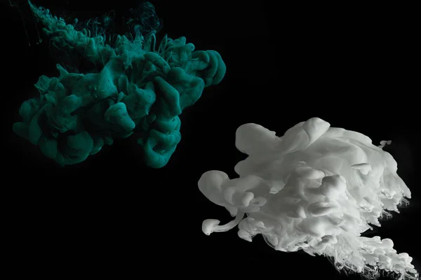 Green and white splashes of paint on black background — Stock Photo