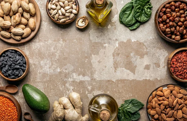 Frame made of nuts, superfoods and healthy ingredients on rustic background with copyspace — Stock Photo