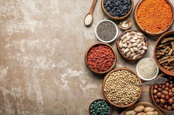 Top view of superfoods, legumes and healthy ingredients on rustic background with copy space — Stock Photo