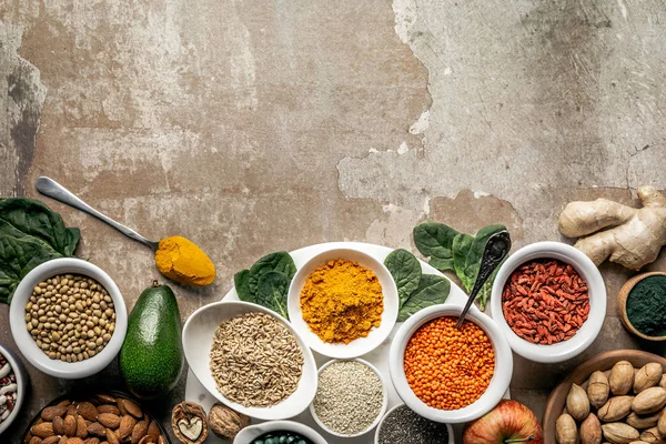 Flat lay of superfoods and legumes on textured rustic background with copy space — Stock Photo