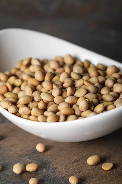 Selective focus of soybean in white bowl on table — Stock Photo
