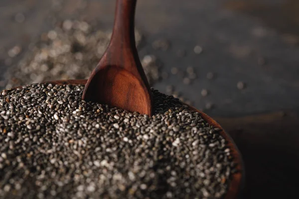 Selective focus of chia seeds in wooden bowl with spoon — Stock Photo
